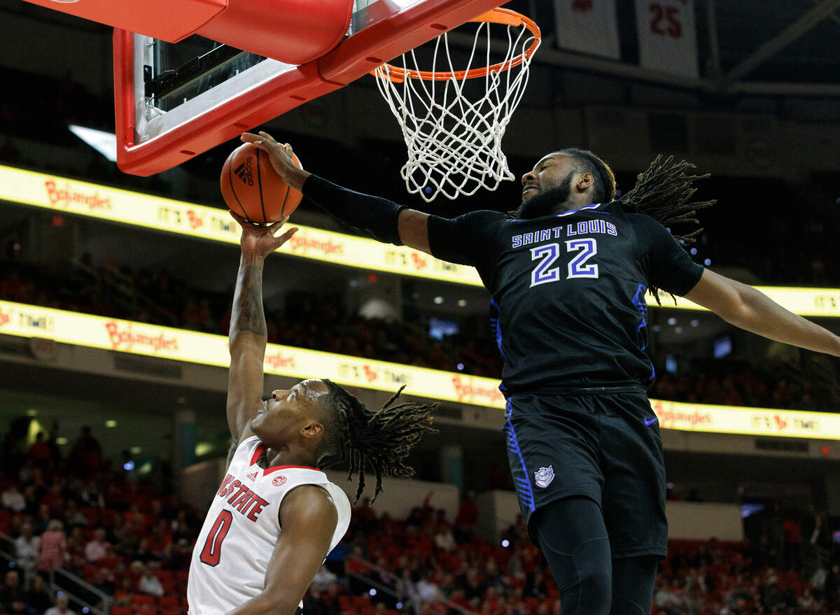 Saint Louis’ Terrence Hargrove Jr. blocks a shot by N.C. State’s DJ Horne during the second half of the Wolfpack’s 82-70 win on Wednesday, Dec. 20, 2023, at PNC Arena in Raleigh, N.C.