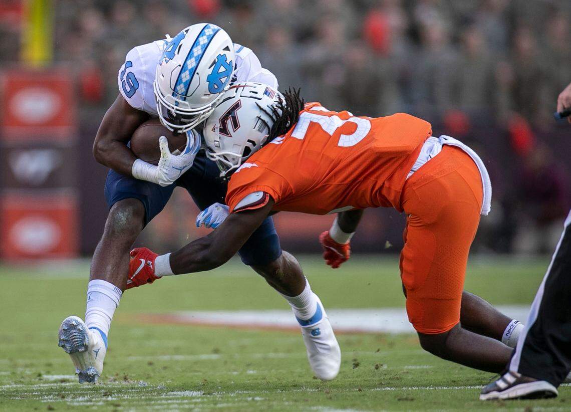 Virginia Tech’s Nasir Peoples (2) stops North Carolina running back Ty Chandler (19) in the second quarter on Friday, September 3, 2021 at Lane Stadium in Blacksburg, Va.