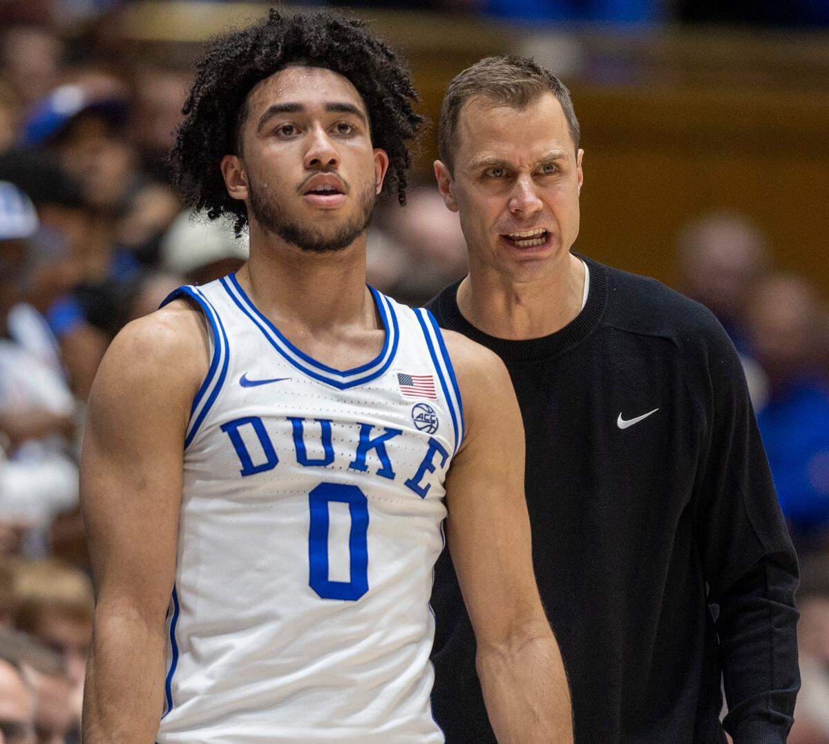 Duke coach Jon Scheyer has a word with Jared McCain (0) as he waits to enter the game in the first half against North Carolina on Saturday, March 9, 2024 at Cameron Indoor Stadium in Durham, N.C.