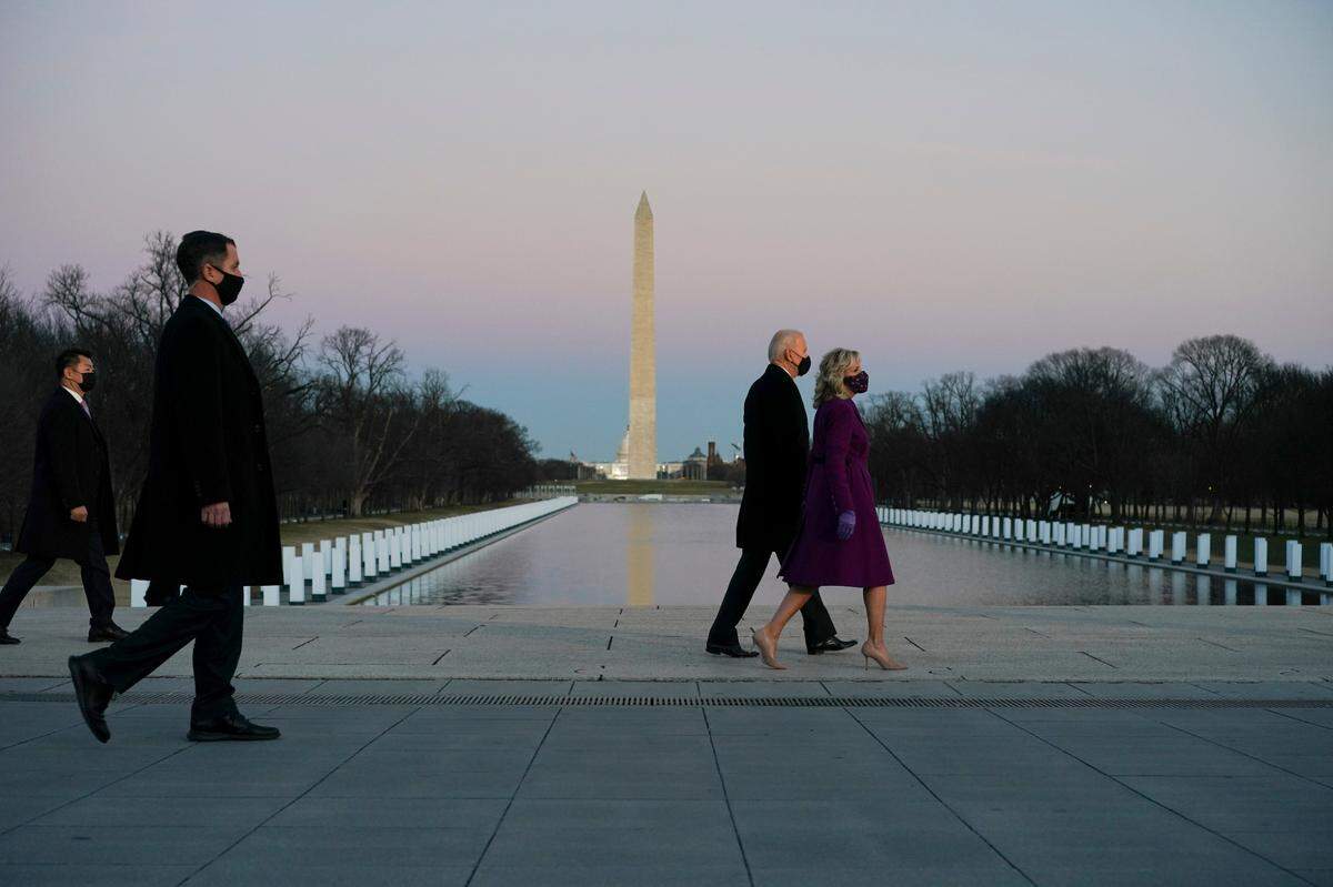 Jill Biden and President-elect Joe Biden at Lincoln Monument Reflecting Pool during a COVID-19 memorial event in Washington on Tuesday evening, Jan. 19, 2021.
