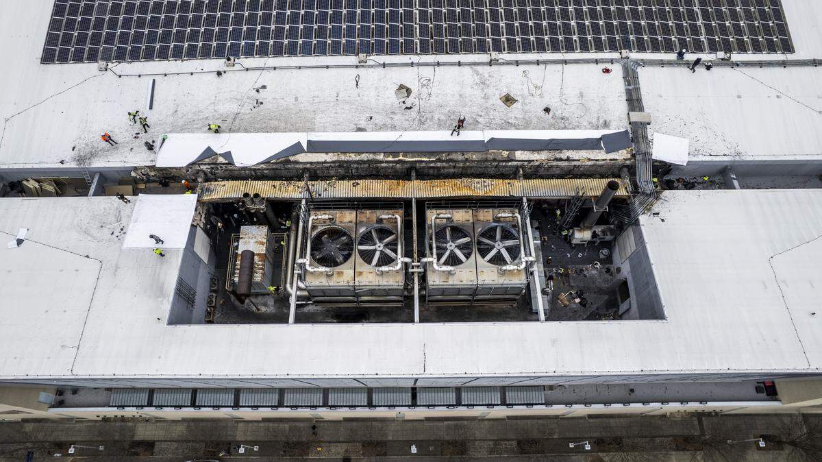 Workers are seen on the roof of the Raleigh Convention Center on Thursday, Dec. 4, 2025, after a Monday night natural gas fire near an HVAC platform caused more than $2 million in damage, according to Raleigh Fire Chief Herbert Griffin. Events scheduled at the center this December are being canceled, postponed or relocated to another venue.