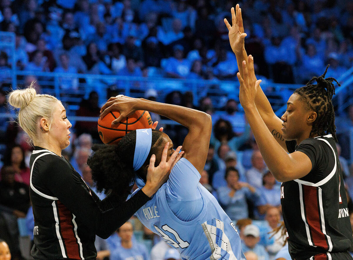 North Carolina’s Anya Poole pulls down a rebound between South Carolina’s Chloe Kitts and Ashlyn Watkins during the second half of the Tar Heels’ 65-58 loss on Thursday, Nov. 30, 2023, at Carmichael Arena in Chapel Hill, N.C.