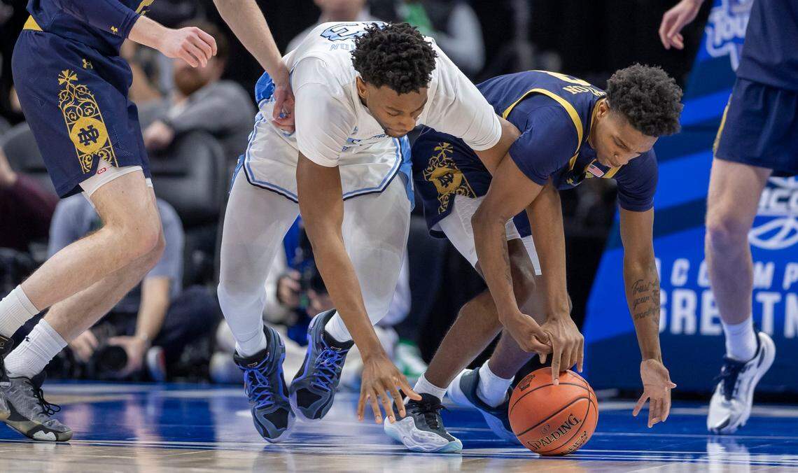 North Carolina forward Jalen Washington (13) battles with Notre Dame’s Marcus Burton (3) for a loose ball in the first half on Wednesday, March 12, 2025 during the second round of the ACC Tournament at Spectrum Center in Charlotte, N.C.