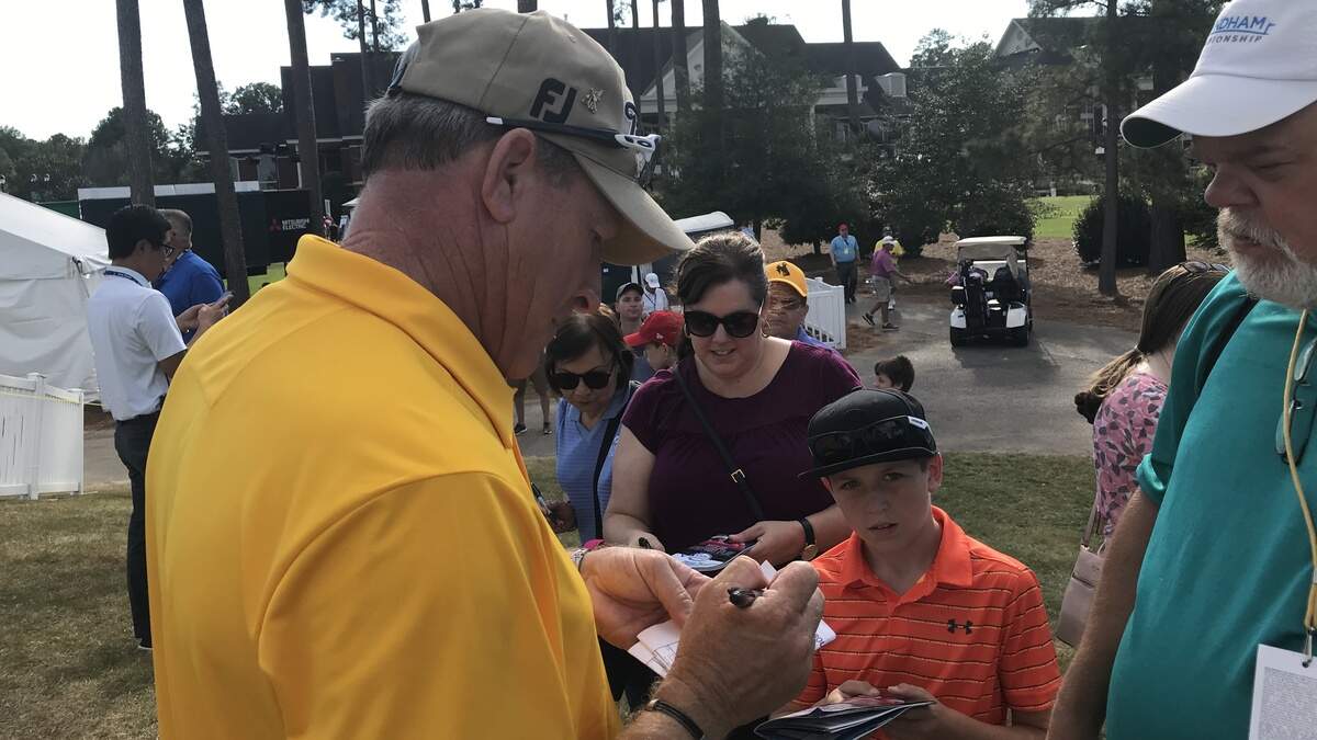 Woody Austin, tied for the lead with Doug Barron after the second round of the SAS Championship, signs autographs for fans at Prestonwood Country Club on Oct. 12, 2019.