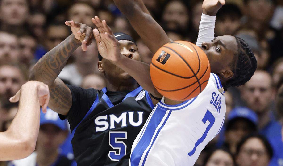 SMU’s Jaron Pierre Jr. (5) passes the ball as Duke’s Dame Sarr (7) defends during the first half of Duke’s game against SMU at Cameron Indoor Stadium in Durham, N.C., Saturday, Jan. 10, 2026.