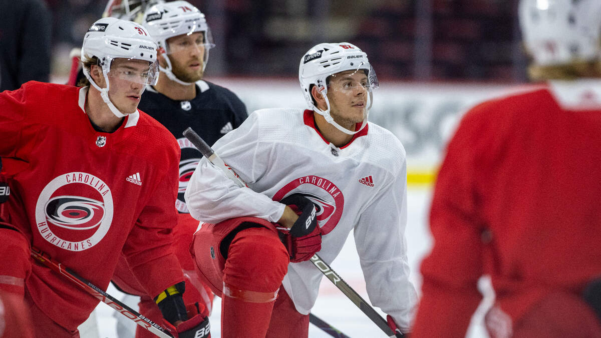 Carolina Hurricanes’ Jesperi Kotkaniemi (82) listens to head coach Rod Brind’Amour during the opening day of camp on Thursday, September 23, 2021 at PNC Arena in Raleigh, N.C.