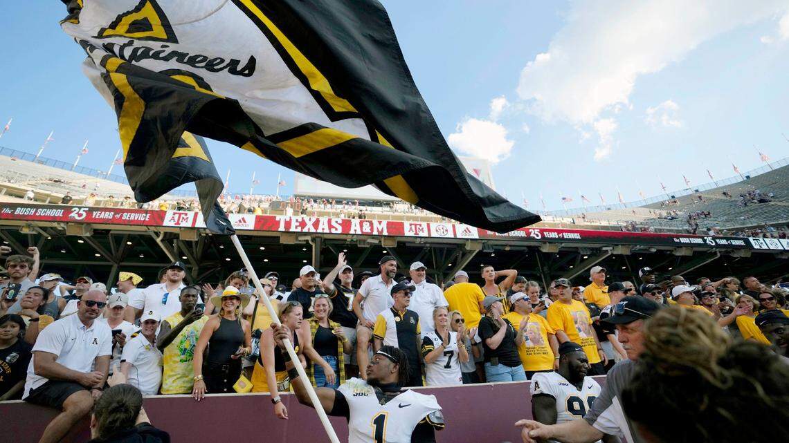 Defensive back Kaleb Dawson (1) waves the Appalachian State University flag inside Kyle Field after the Mountaineers upset No. 6 Texas A&M 17-14 on Saturday, Sept. 10, 2022, in College Station, Texas.