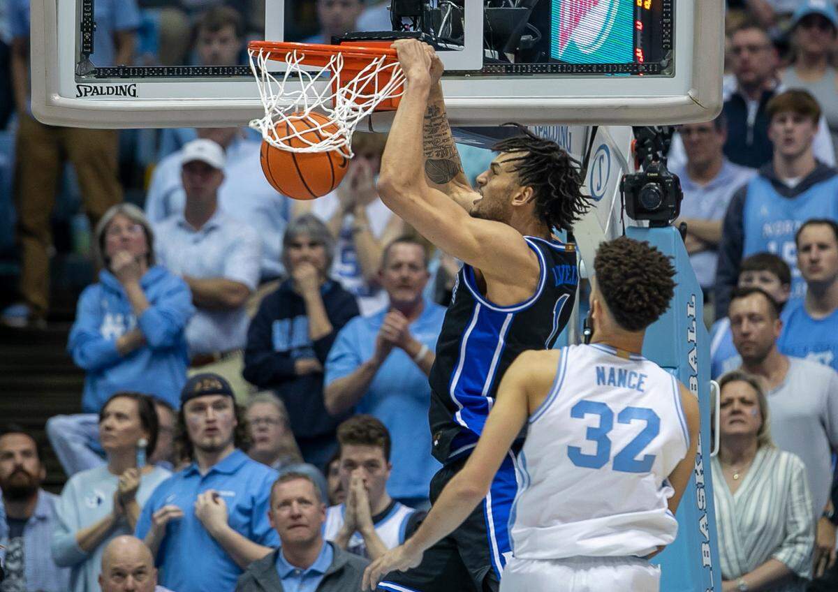 Duke’s Dereck Lively II (1) dunks over North Carolina’s Pete Nance (32) to tie the score 49-49 in the second half on Saturday, March 4, 2023 at the Smith Center in Chapel Hill, N.C.