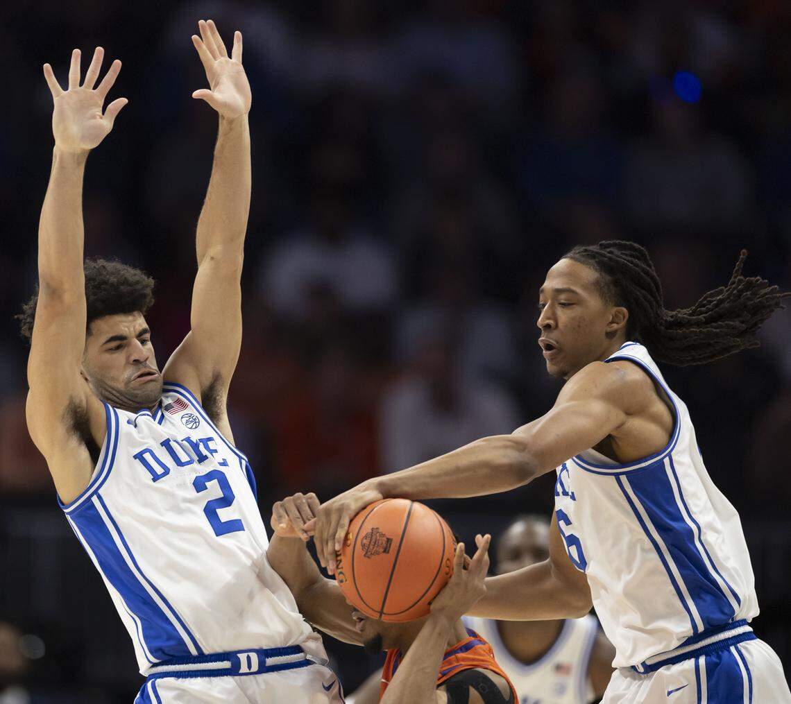 Duke guard Cayden Boozer (2) and forward Isaiah Evans (3) trap Clemson guard Ace Buckner (21) in the first half on Friday, March 13, 2026, during the semifinals of the ACC Tournament at Spectrum Center in Charlotte, N.C.