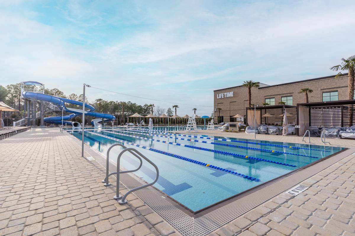 A 60,000-square-foot outdoor pool deck features outdoor dining and six pickleball courts at the new Life Time at Alston Town Center in West Cary.