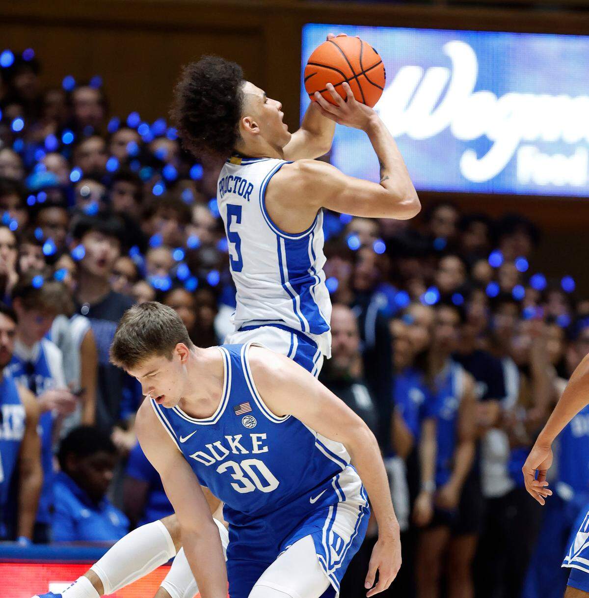 Duke’s Tyrese Proctor (5) shoots after being fouled by Kyle Filipowski (30) during the Blue-White scrimmage during Duke’s Countdown to Craziness at Cameron Indoor Stadium in Durham, N.C., Friday, Oct. 21, 2022.