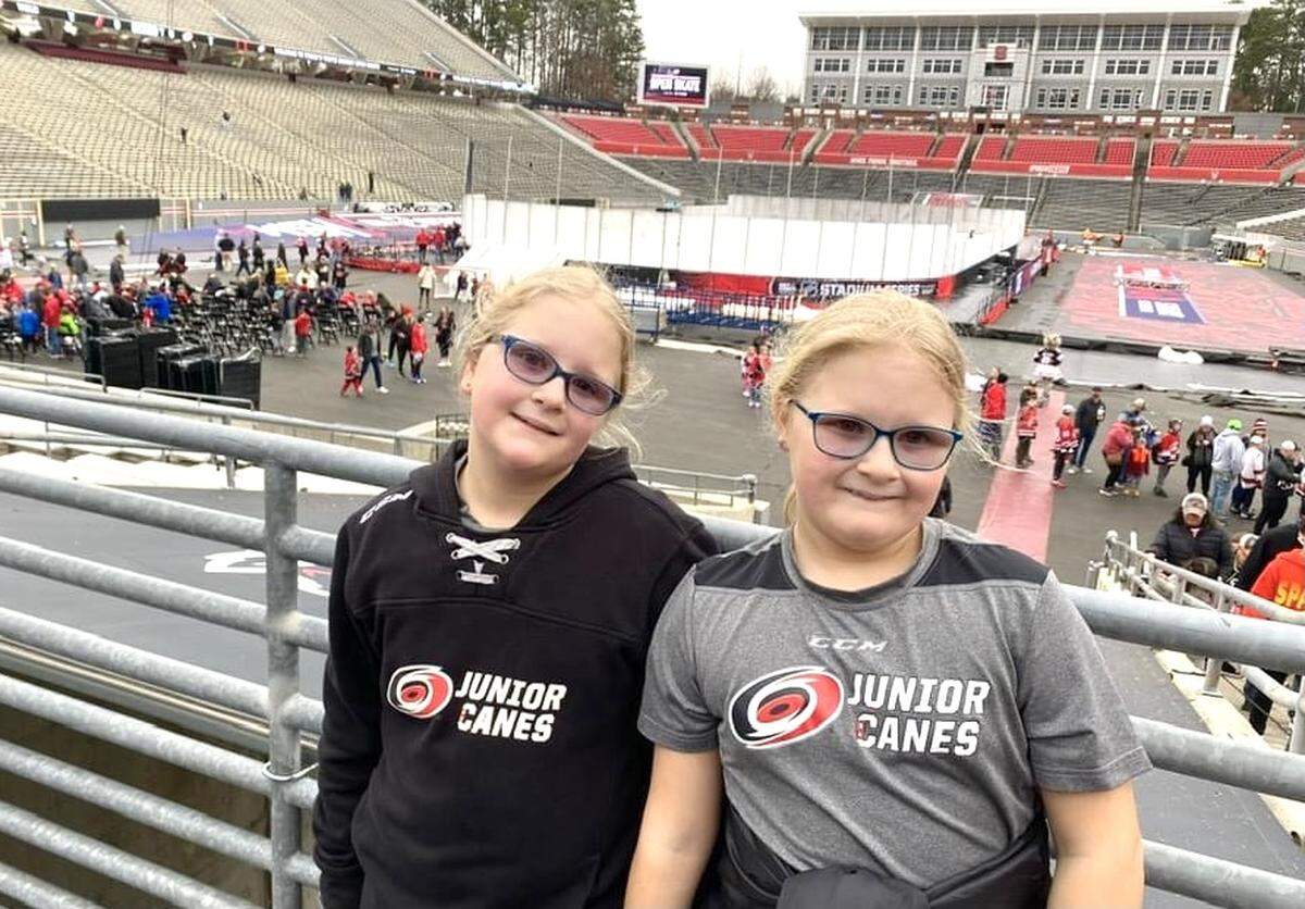 Erin, left, and Emma Pelletier take in the sights at Carter-Finley Stadium after the Hurricanes hosted the NHL Stadium Series in February 2023.