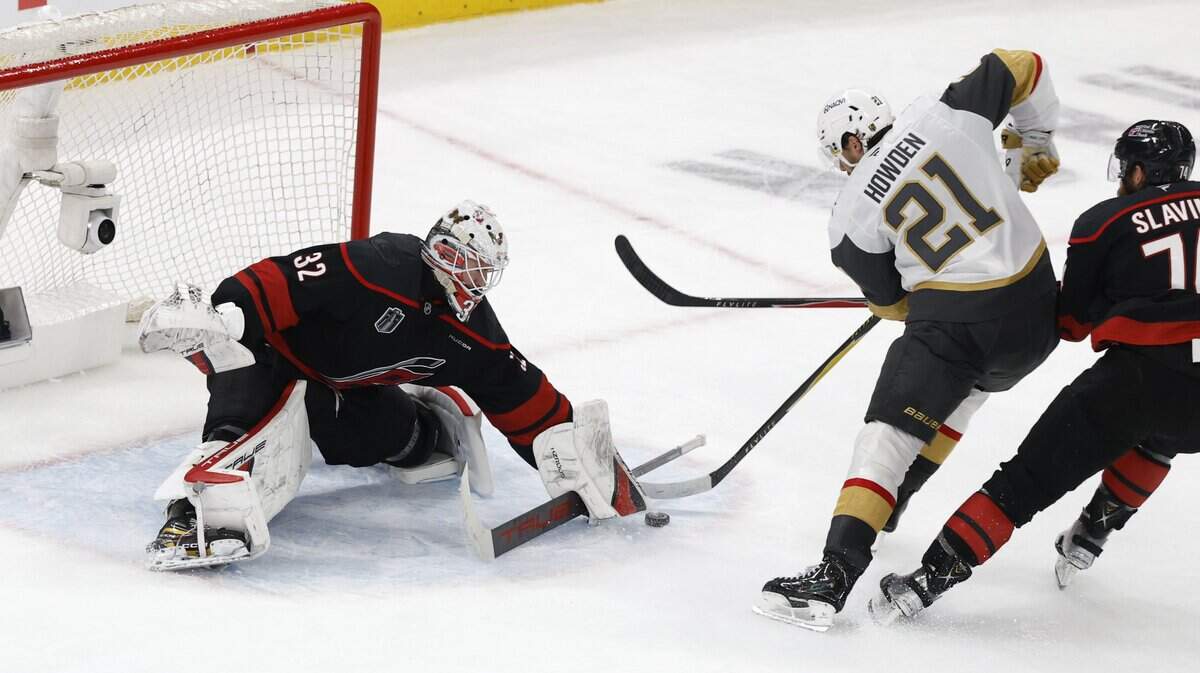 Carolina's Brandon Bussi (32) makes the save as Vegas’ Brett Howden (21) tries to get the puck into the net in the second period of the Hurricanes’ game against the Golden Knights in the fifth game of the Stanley Cup Final at the Lenovo Center in Raleigh, N.C., Thursday, June 11, 2026.