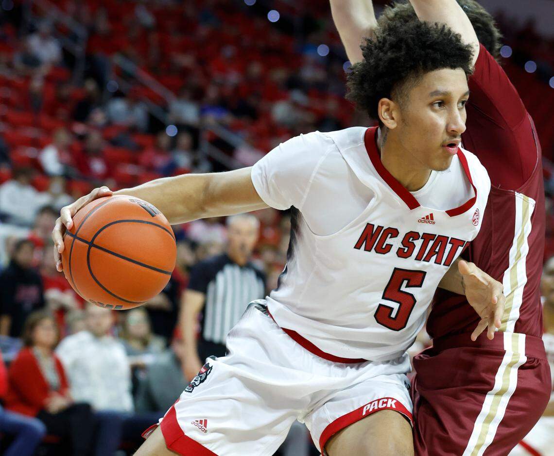 N.C. State’s Jack Clark (5) drives around Elon’s Max Mackinnon (3) during the second half of N.C. State’s 74-63 victory over Elon at PNC Arena in Raleigh, N.C., Saturday, Nov. 19, 2022.