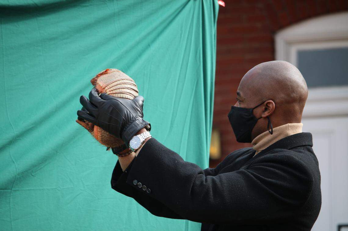Apex Mayor Jacques Gilbert holds Sylvia the Armadillo on Groundhog Day 2021. Sylvia predicted six more weeks of winter.