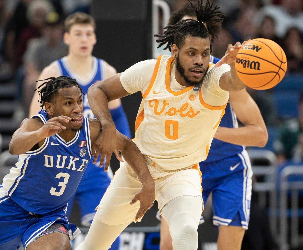 Duke’s Jeremy Roach (3) and Tennessee’s Jonas Aidoo (0) battle for a loose ball in the first half during the second round of the NCAA Tournament on Saturday, March 18, 2023 at the Amway Center in Orlando, Fla.