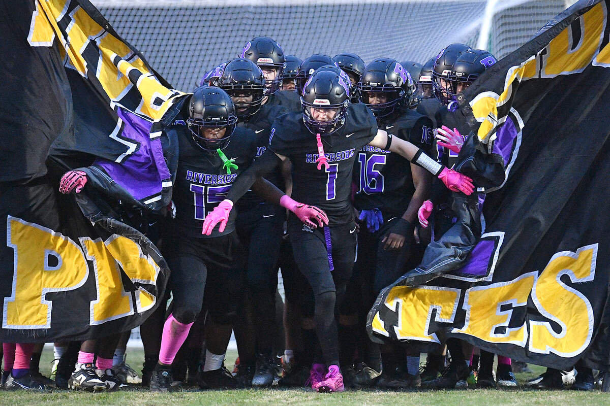 Riverside’s Cole Schweitz (1) and the Riverside Pirates run onto the field before their game with Hillside. The Durham Hillside Hornets and the Durham-Riverside Pirates met in a football game in Durham. N.C. on October 4, 2024.
