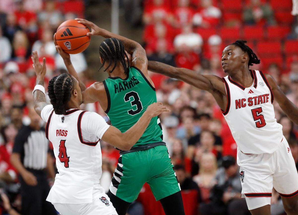 N.C. State’s Breon Pass and Trey Parker pressure USC Upstate’s Brit Harris during the first half of the Wolfpack’s 97-66 win on Monday, Nov. 4, 2024, at Lenovo Center in Raleigh, N.C.