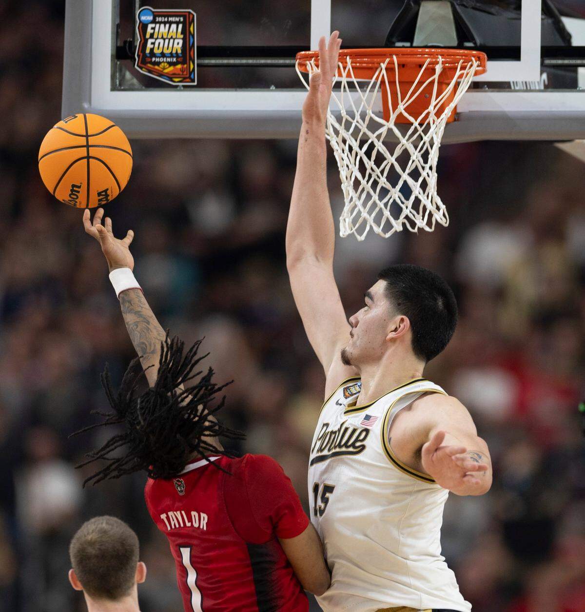 Purdue’s Zach Edey (15) blocks a set attempt by N.C. State’s Jayden Taylor (1) during the second half in the NCAA Final Four National Semifinal game on Saturday, April 6, 2024 at State Farm Stadium in Glendale, AZ.