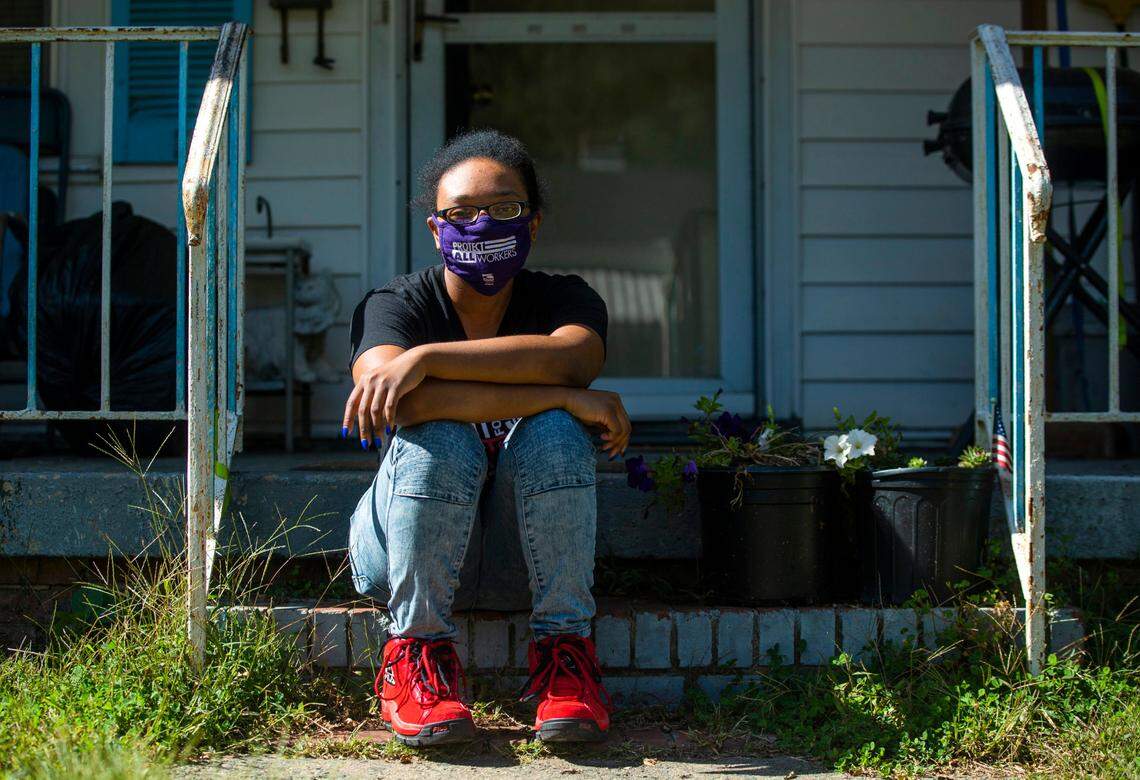 Jamila Allen sits for a portrait on her front porch while on strike and self-quarantining, though initially testing negative, after coming in contact with COVID-19 during a shift at Freddy’s Frozen Custard & Steakburgers last week, on Monday, Oct. 19, 2020, in Durham, N.C.