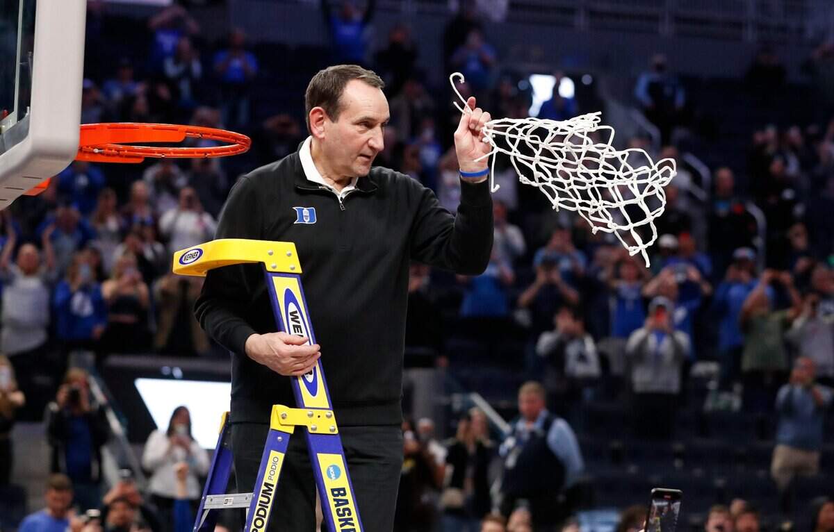 Duke head coach Mike Krzyzewski holds up the net after cutting it down after Dukeís 78-69 victory over Arkansas in the NCAA Tournament West Regional finals at the Chase Center in San Francisco, Calif., Saturday, March 26, 2022.