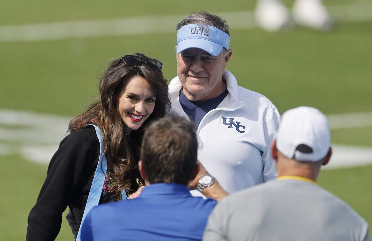 North Carolina head coach Bill Belichick and his girlfriend Jordon Hudson pose for a photo before UNC’s game against Richmond at Kenan Stadium in Chapel Hill, N.C., Saturday, Sept. 13, 2025.