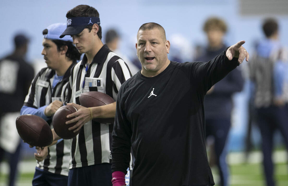 North Carolina offensive coordinator Phil Longo works with players during the Tar Heels’ practice at their indoor practice facility on Tuesday, April 2, 2019 in Chapel Hill, N.C.