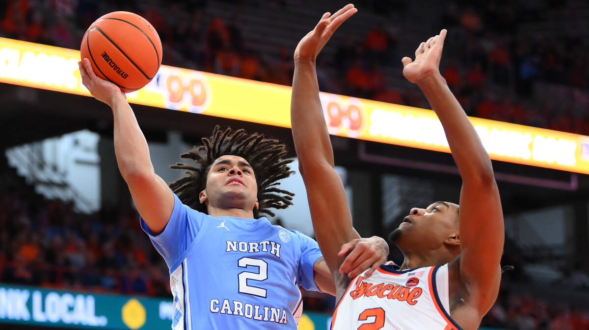 Feb 13, 2024; Syracuse, New York, USA; North Carolina Tar Heels guard Elliot Cadeau (2) shoots the ball as Syracuse Orange guard JJ Starling (2) defends during the first half at the JMA Wireless Dome.