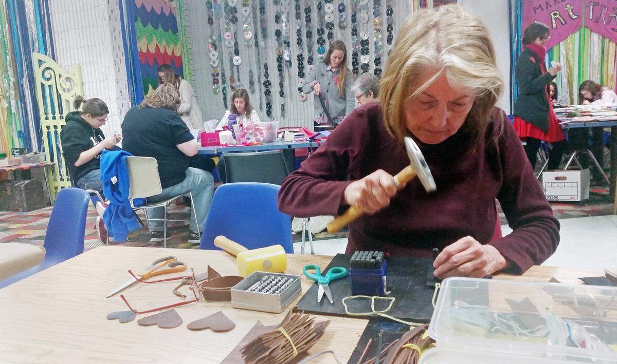 Inez Van Arsdall works to create a leather bookmark  at The Scrap Exchange in Durham in 2017. The Scrap Exchange is one of the places in the Triangle for people to buy craft supplies and take classes.
