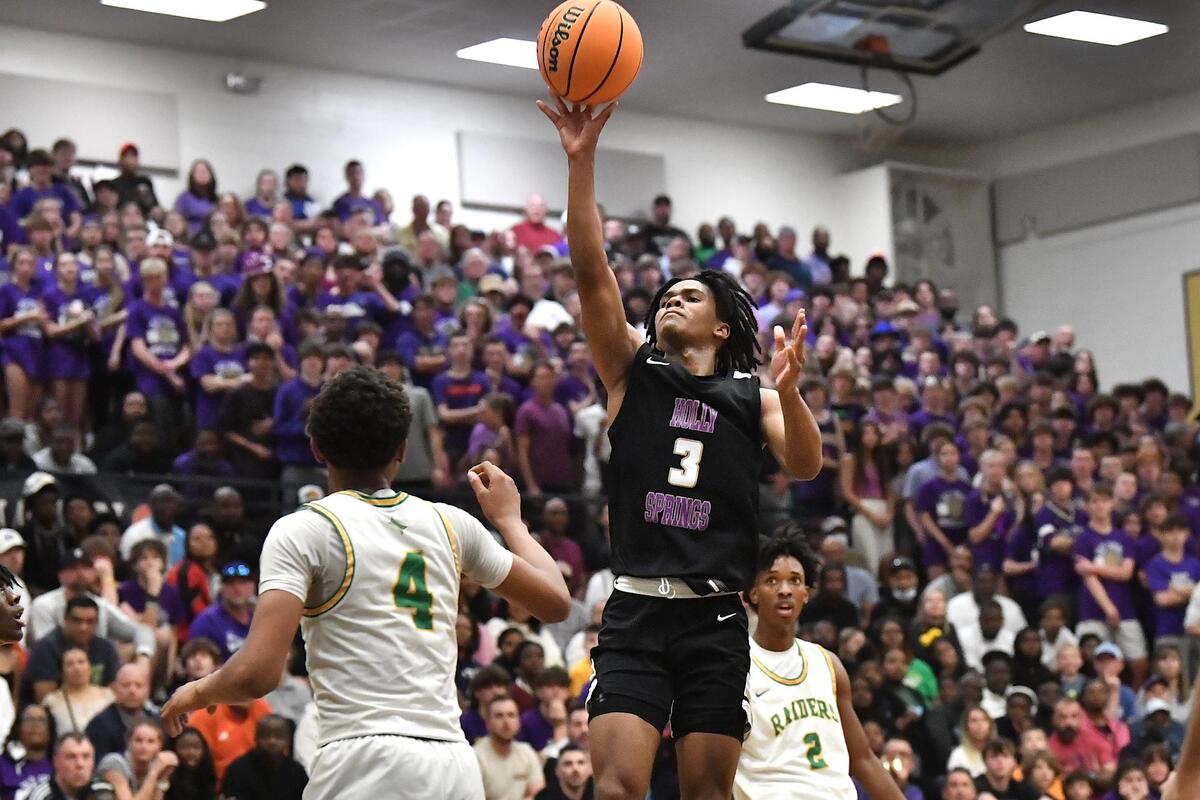Holly Springs’ Micah Jones (3) takes the layup overRichmond’s Zion Baldwin (4) in the first half. The Richmond Raiders and the Holly Springs Golden Hawks met in the NCHSAA 4A East Regional Finals in Sanford, N.C. on March 4, 2023.