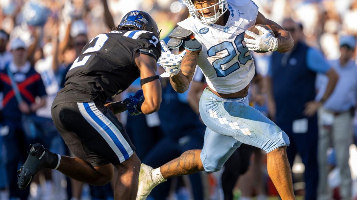 North Carolina running back Omarion Hampton (28) stiff arms Duke safety Jaylen Stinson (2) as he picks up 37-yards after a reception from quarterback Jacolby Criswell in the second quarter on Saturday, September 28, 2024 at Wallace Wade Stadium in Durham, N.C.