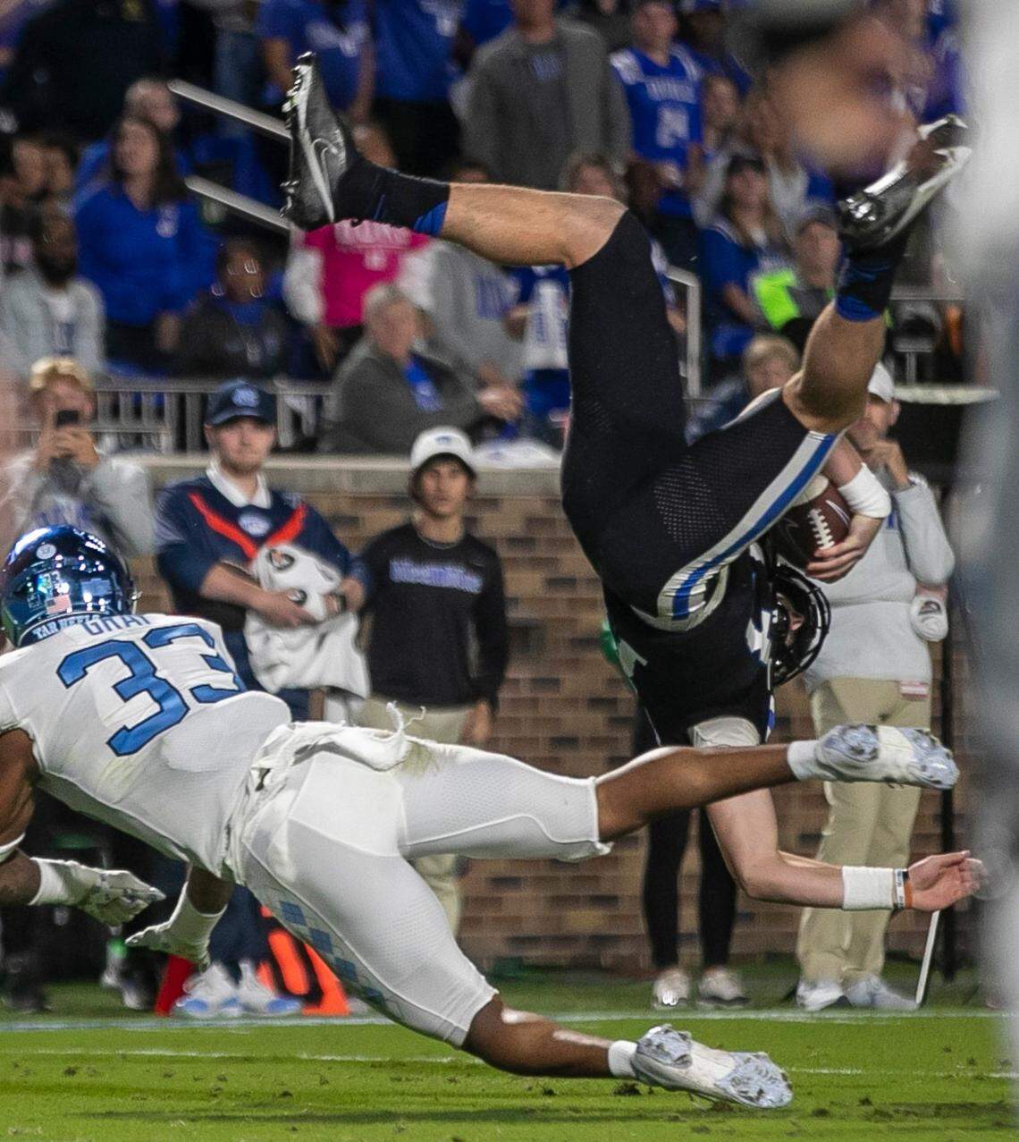 Duke quarterback Riley Leonard (13) is upended by North Carolina’s Cedric Gray (33) in the first quarter on Saturday, October 15, 2022 at Wallace-Wade Stadium in Durham, N.C.
