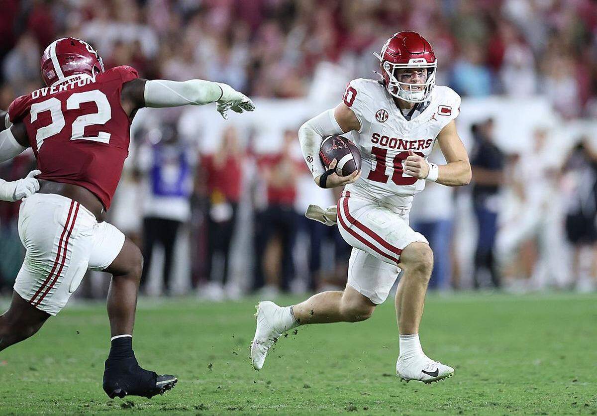 John Mateer (10) of the Oklahoma Sooners rushes against the Alabama Crimson Tide during the third quarter at Bryant-Denny Stadium on Nov. 15, 2025 in Tuscaloosa, Alabama.