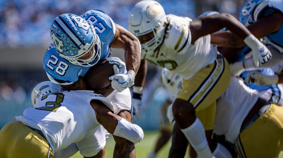 Georgia Tech defensive back Ahmari Harvey (3) stops North Carolina running back Omarion Hampton (28), short of the goal line, after a nine-yard gain to set up a touchdown in the first quarter on Saturday, October 12, 2024 at Kenan Stadium in Chapel Hill, N.C.