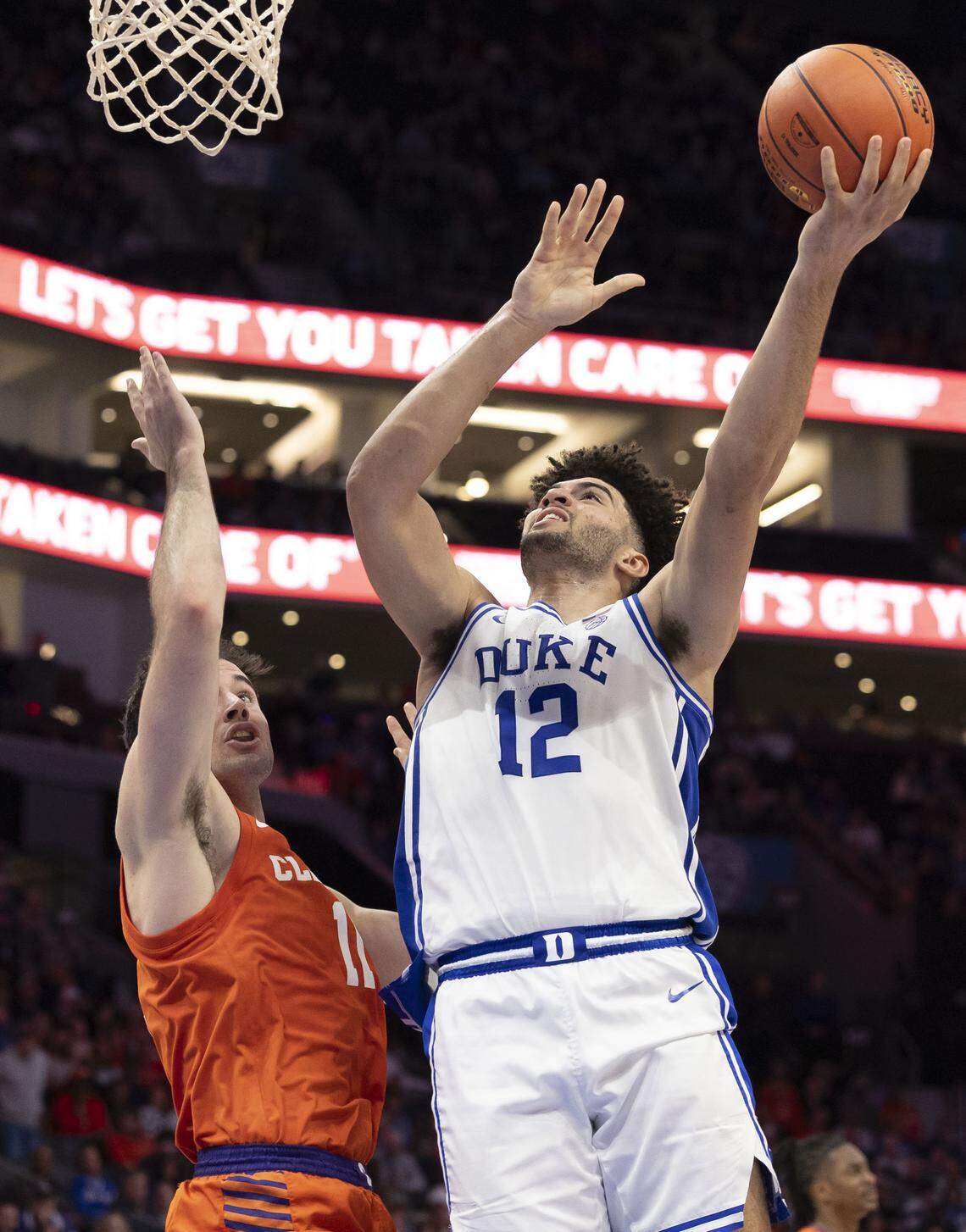 Duke forward Cameron Boozer (12) drives to the basket against Clemson forward Nick Davidson (11) in the first half on Friday, March 13, 2026, during the semifinals of the ACC Tournament at Spectrum Center in Charlotte, N.C.