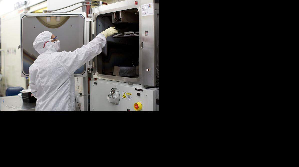 A Cree semiconductor pperator Linda Mathew working in a “clean room” environment on Friday, August 15, 2014 in Research Triangle Park, N.C.