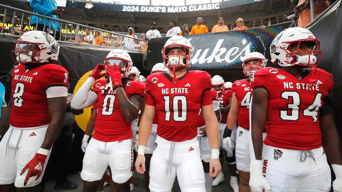 N.C. State’s Devon Betty (8), Sean Brown (0), Caden Fordham (10) and Kamal Bonner (34) get ready to take the field to warmup before the Wolfpack’s game against Tennessee in the Duke’s Mayo Classic at Bank of America Stadium in Charlotte, N.C., Saturday, Sept. 7, 2024.