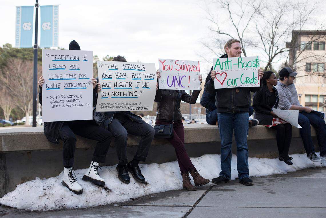 Anti-racist protesters gathered outside the Dean Smith Center to express congratulations to graduates on fall commencement day, Sunday, Dec. 16, 2018.
