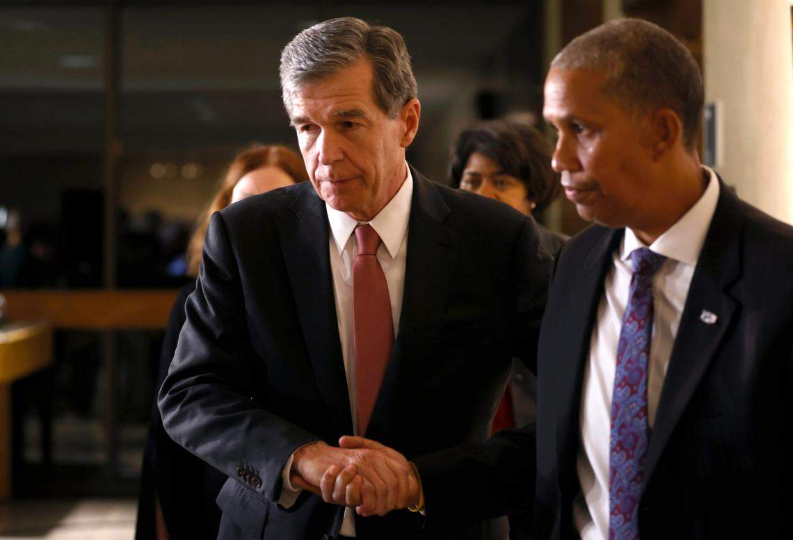 North Carolina Gov. Roy Cooper walks through the Raleigh municipal building following a press briefing about a shooting that left five people dead on Thursday, Oct. 13, 2022, in Raleigh, N.C.