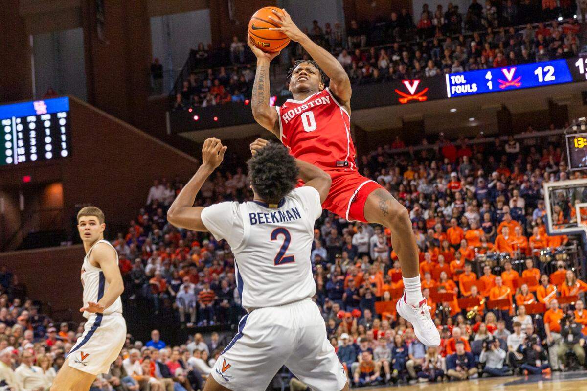 Houston guard Marcus Sasser (0) shoots over Virginia’s Reece Beekman (2) during the first half of an NCAA college basketball game in Charlottesville, Va., Saturday, Dec. 17, 2022. (AP Photo/Erin Edgerton)