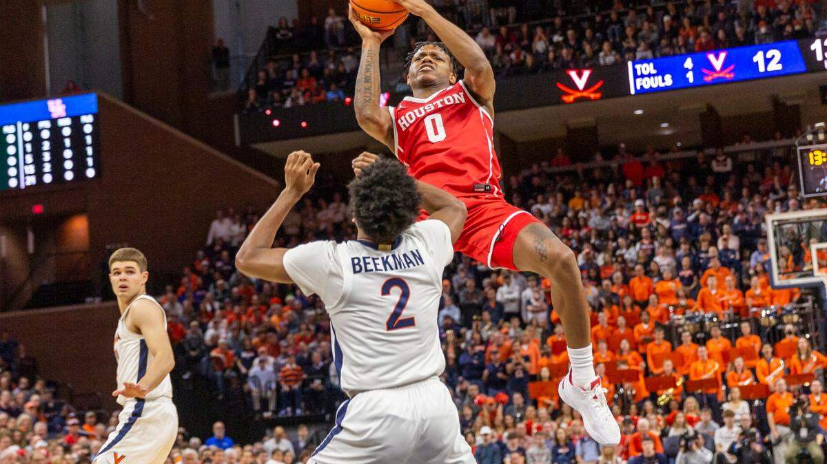 Houston guard Marcus Sasser (0) shoots over Virginia’s Reece Beekman (2) during the first half of an NCAA college basketball game in Charlottesville, Va., Saturday, Dec. 17, 2022. (AP Photo/Erin Edgerton)