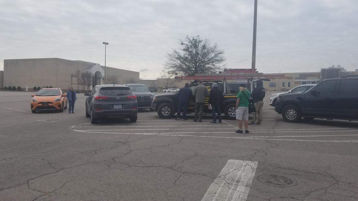 U.S. Immigration and Customs Enforcement agents surround a man and his daughter at the Cary Towne Center on March 19, 2020.