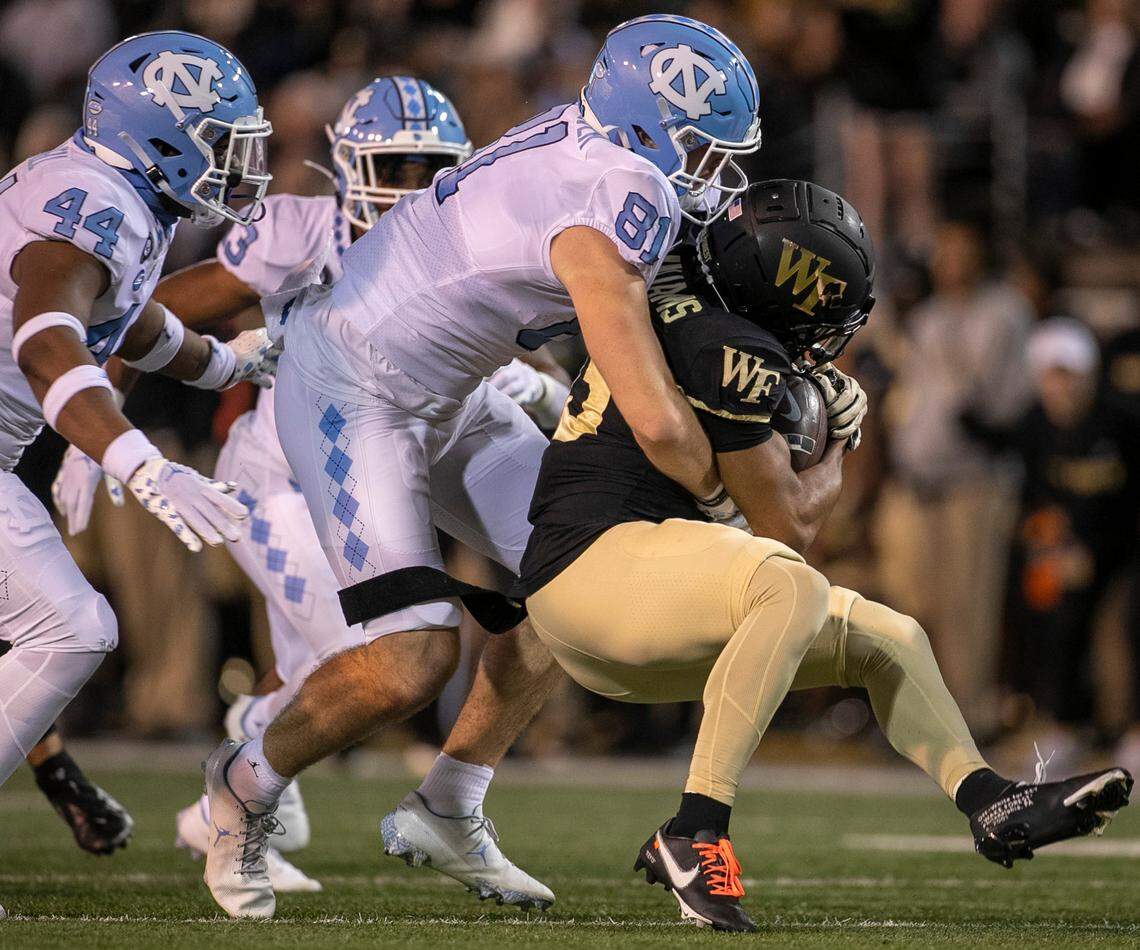 North Carolina’s John Copenhaver (81) stops Wake Forest’s Ke’Shawn Williams (13) after a 12-yard kick off return in the first quarter on Saturday, November 12, 2022 at Truist Field in Winston-Salem, N.C.