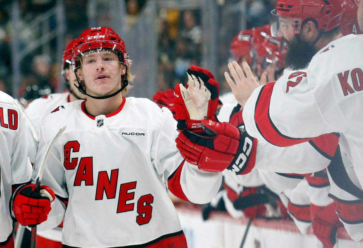 Carolina Hurricanes right wing Jackson Blake (53) celebrates with the Carolina Hurricanes bench after scoring a goal against the Pittsburgh Penguins during the first period at PPG Paints Arena.