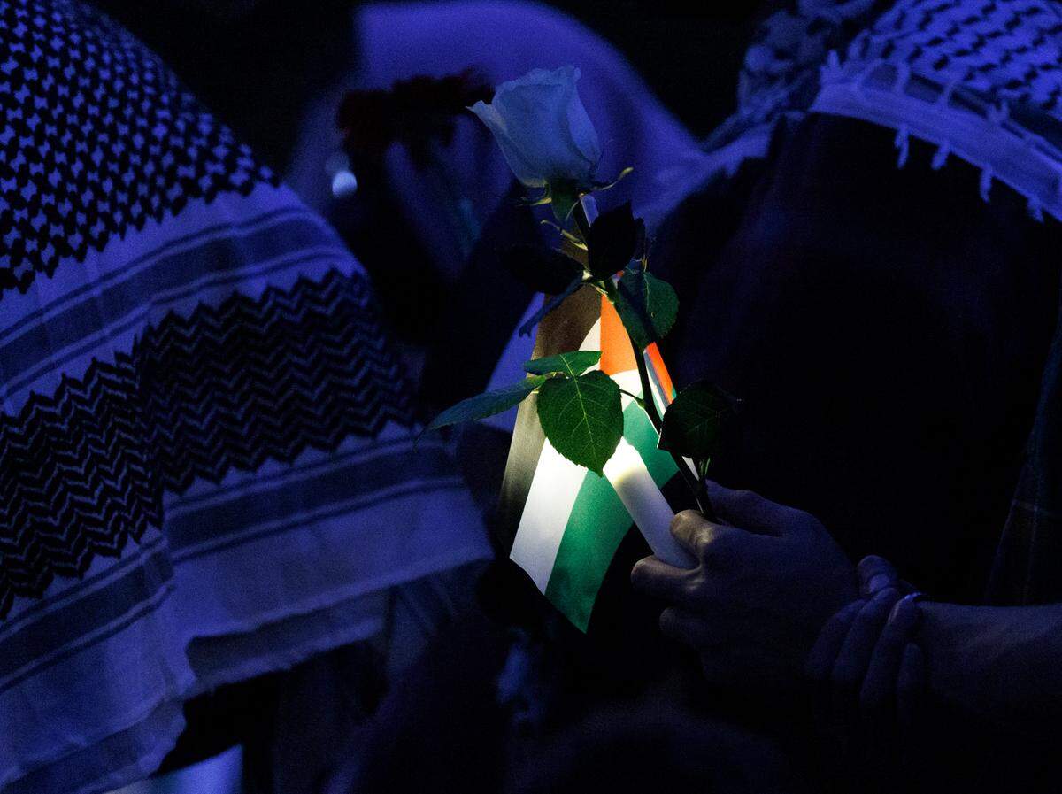 A person holds a Palestinian flag during a vigil held by the UNC chapter of Students for Justice in Palestine on Monday, Oct. 7, 2024, in Chapel Hill, N.C. The vigil was intended to honor those who have been killed during Israel’s counter-campaign against Hamas in the past year.