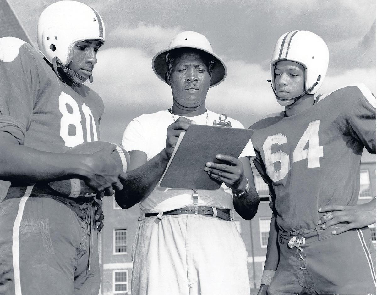 From left, Ernest Barnes, line coach Carl Easterling and Bobby McNeil at Hillside High School in Durham in 1954. Coming out of high school, Barnes was offered 26 athletic scholarships but decided to attend North Carolina College at Durham, which eventually became North Carolina Central University.