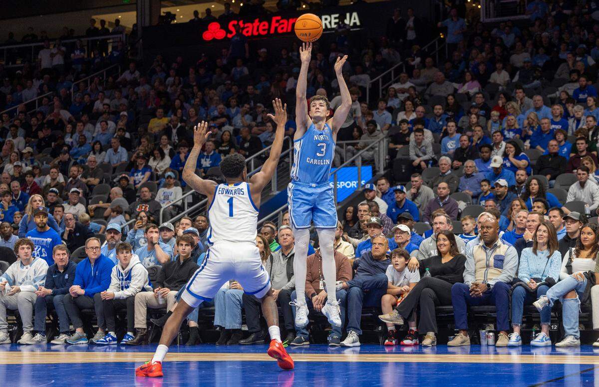 North Carolina’s Cormac Ryan (3) launches a three point shot over Kentucky’s Justin Edwards (1) in the second half on Saturday, December 16, 2023 at State Farm Arena in Atlanta, Georgia. Ryan scored 20 points.
