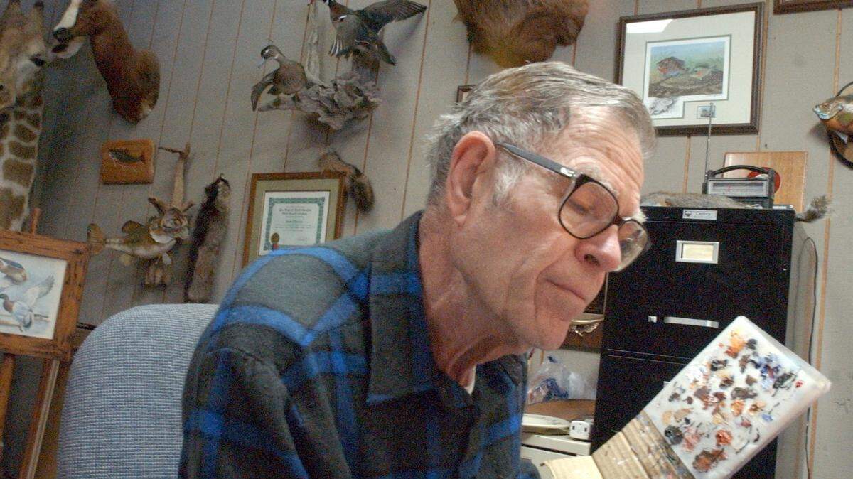 Duane Raver Jr. in 2003 working on a painting in a small area in his daughter’s taxidermy business where he worked.
