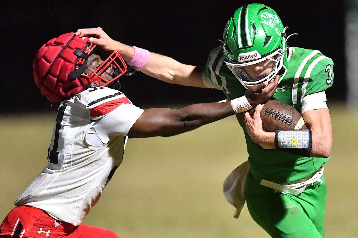 Middle Creek's Jabron Wilson (31) face masks Cary Quarterback Nick Grena (3) during the first half and resulting in a first down. The Cary Imps and the Middle Creek Mustangs met in a conference football game in Cary, N.C. on October 24, 2025