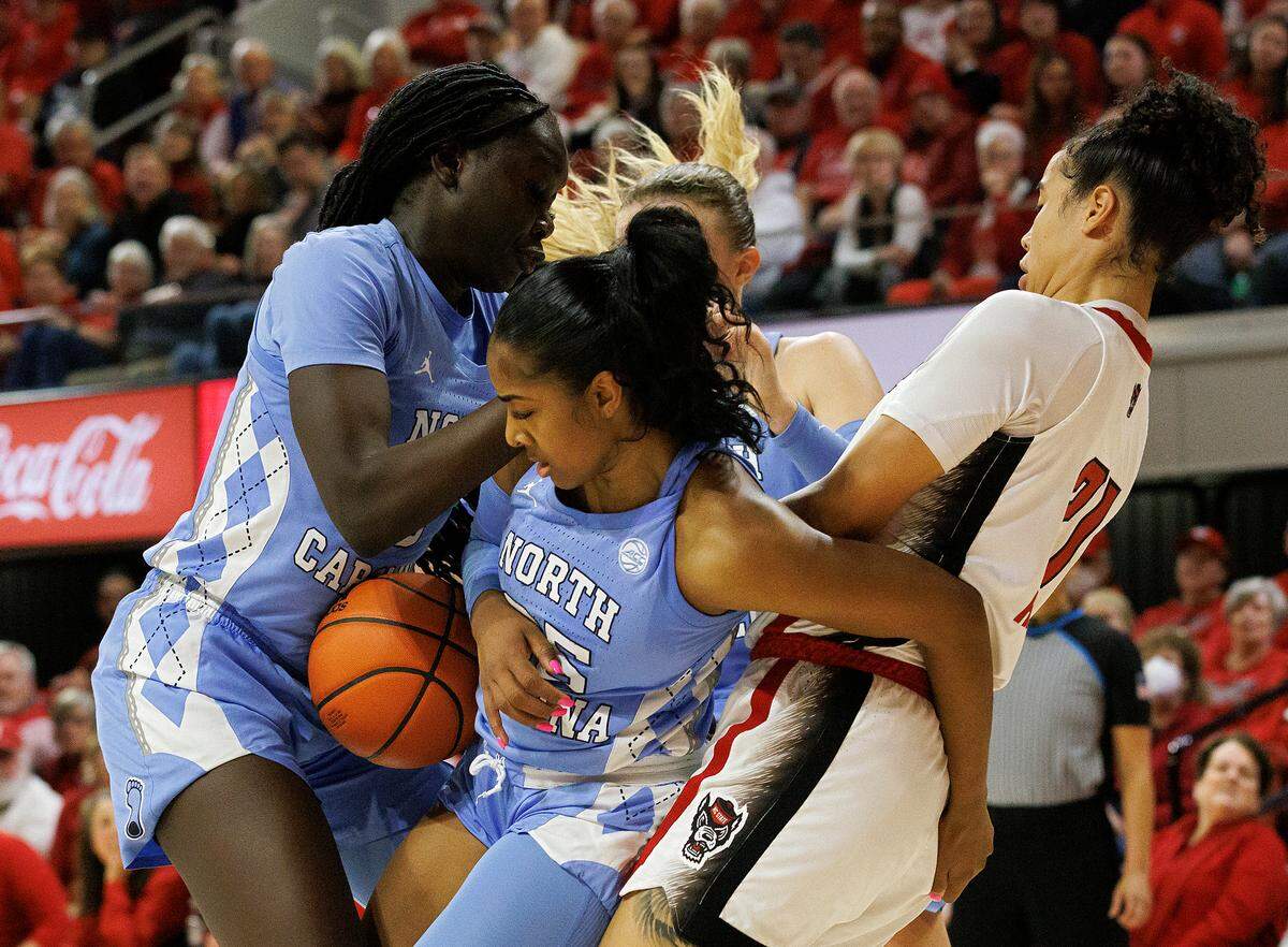 North Carolina’s Deja Kelly (25) tangles with N.C. State’s Madison Hayes for a rebound during the second half of the Wolfpack’s 63-59 win on Thursday, Feb. 1, 2024, at Reynolds Coliseum in Raleigh, N.C.